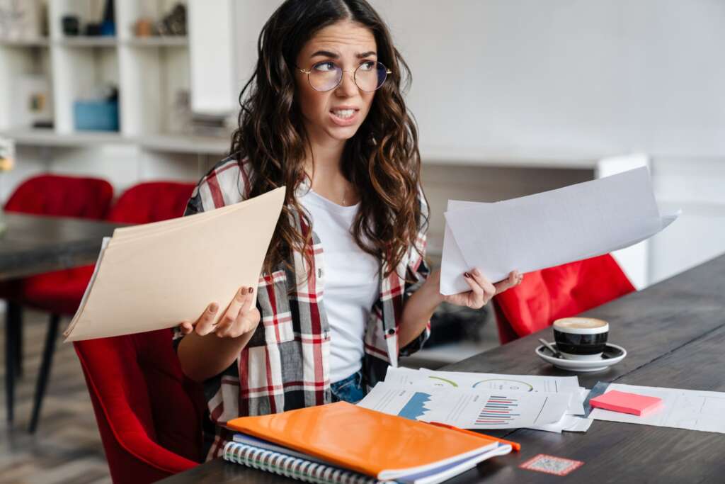 Confused fruustrated young woman working